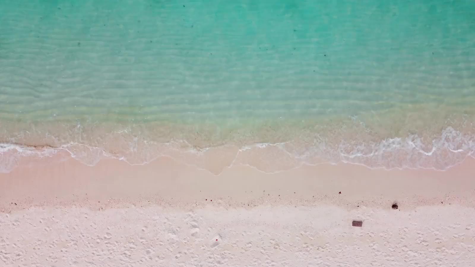 Calm surf on an empty stretch of sand